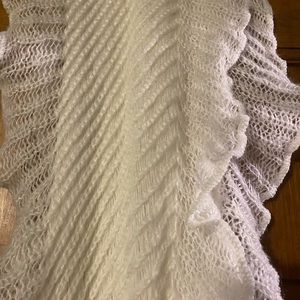 Cream colored soft cotton like scarf. 110" x 10" with ruffled sides.